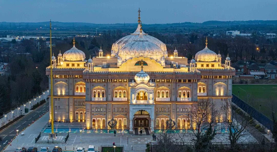 Illuminated Gurdwara building in Gravesend at dusk